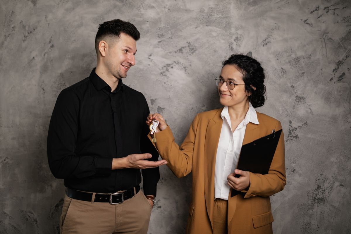 Agent handing keys to a new tenant