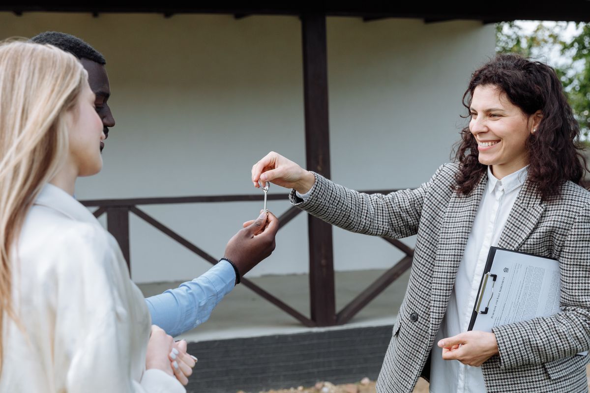 Property manager handing keys to an owner